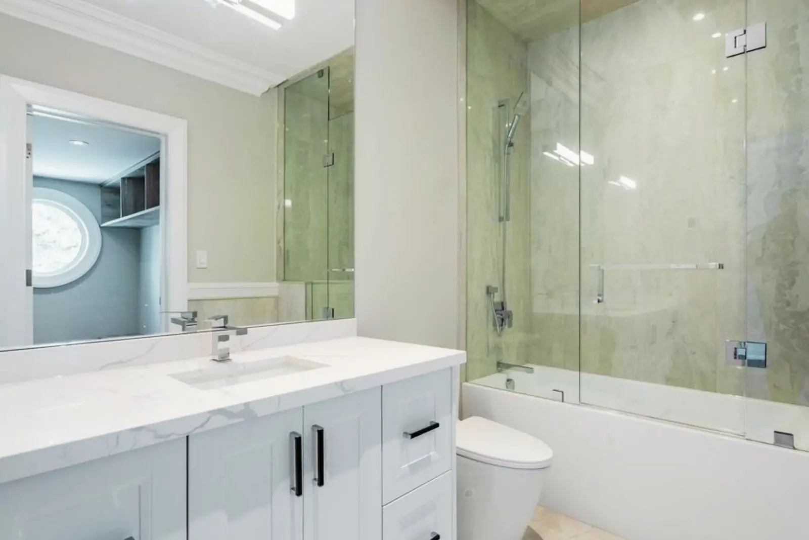 Crisp white shaker vanity with matte black pulls