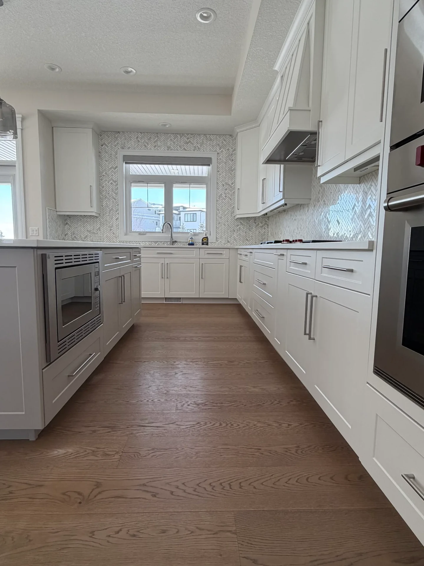 Bright White Galley with Herringbone Backsplash